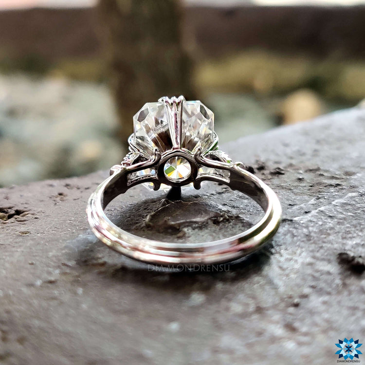 Radiant cut moissanite ring featuring fishtail prong setting.