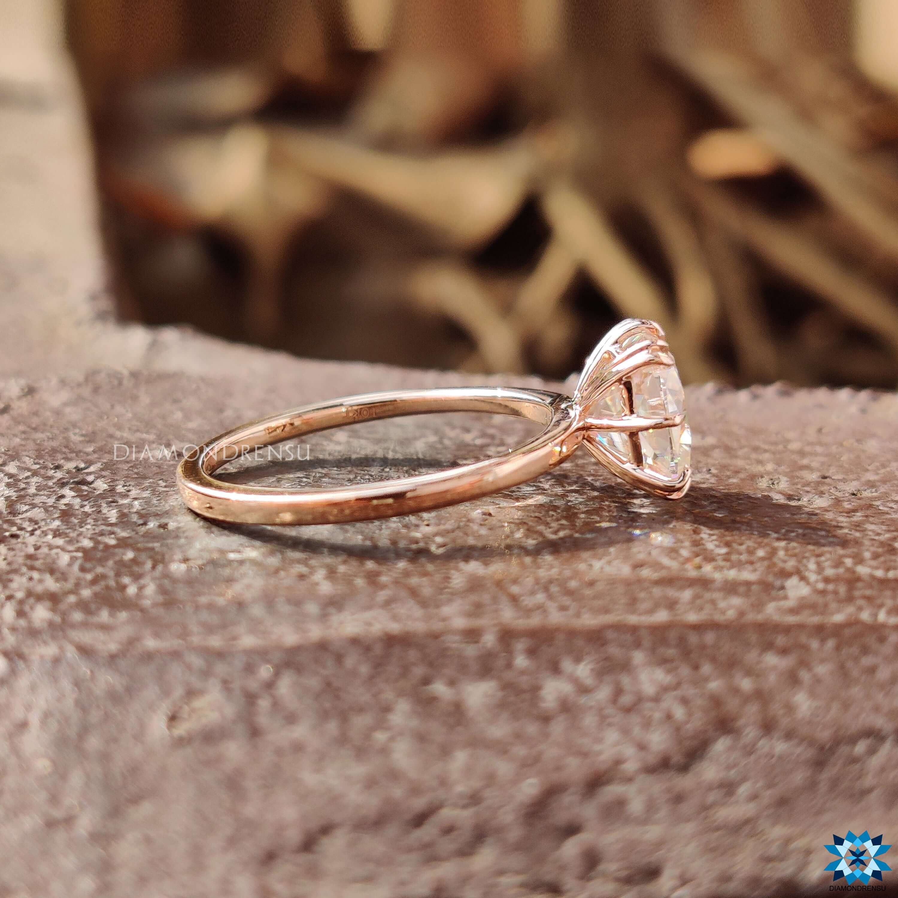 Rose gold engagement ring with double claw prongs.
