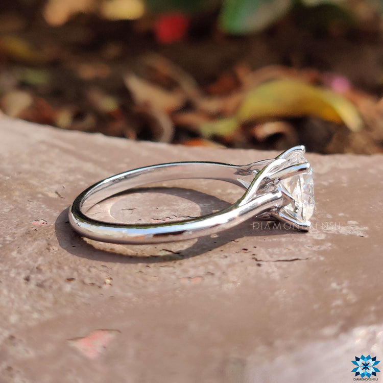 Solitaire ring with Cushion Rensu cut moissanite and prong mount.
