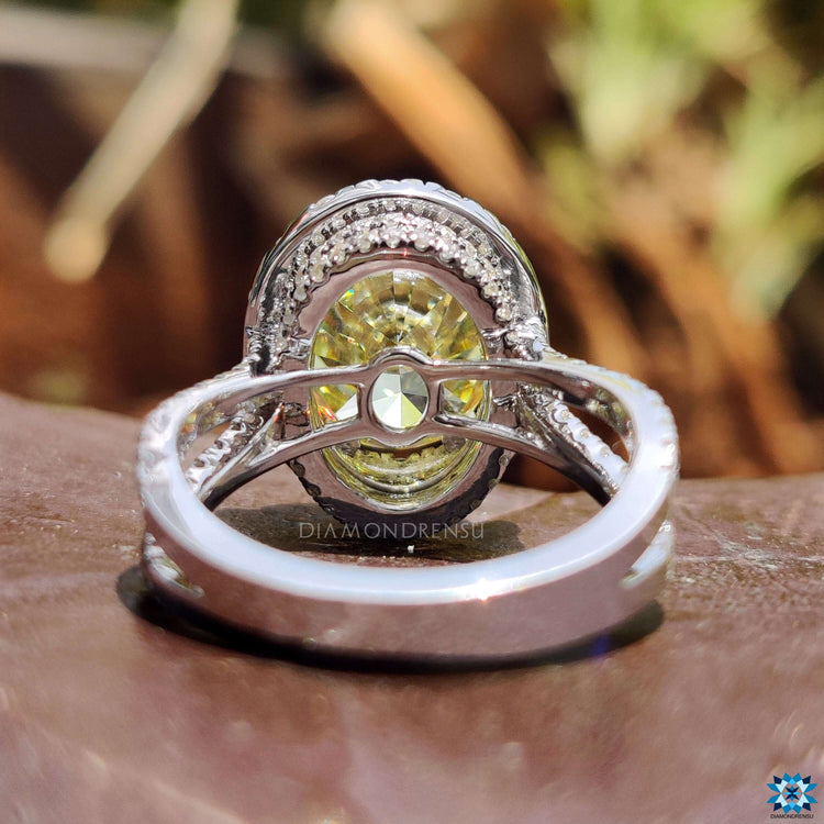 Oval canary yellow moissanite ring with split pave band.