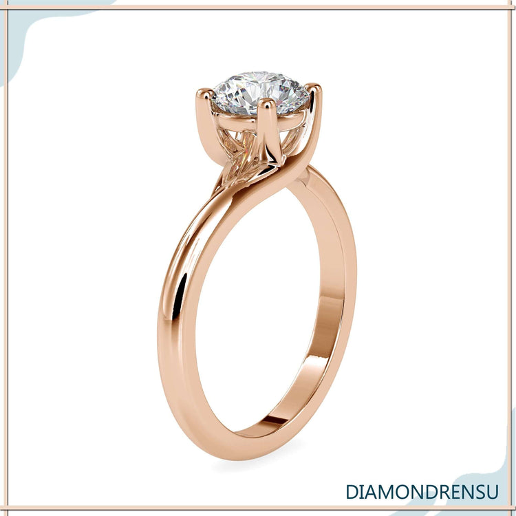 Simple diamond ring in solitaire style with round cut diamond.
