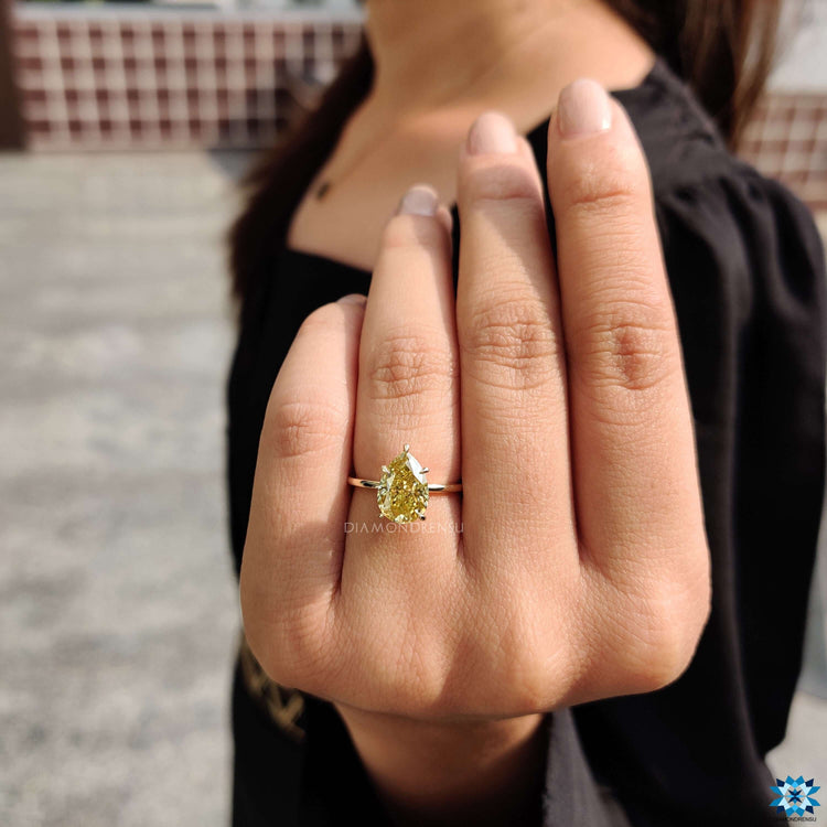 Canary yellow moissanite ring in pear cut shape.