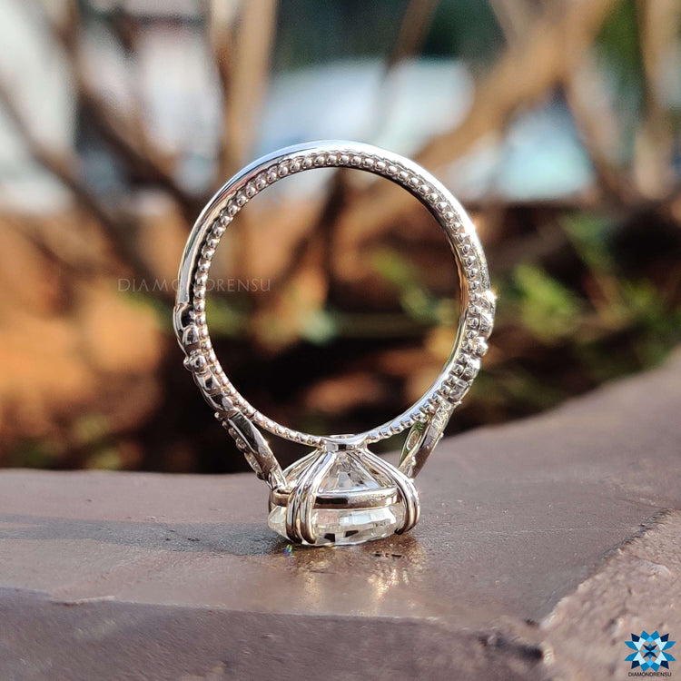 White gold ring featuring an oval cut moissanite in a prong setting.