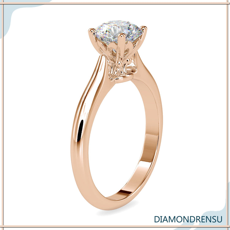 Handmade ring in rose gold with solitaire knife edge setting.