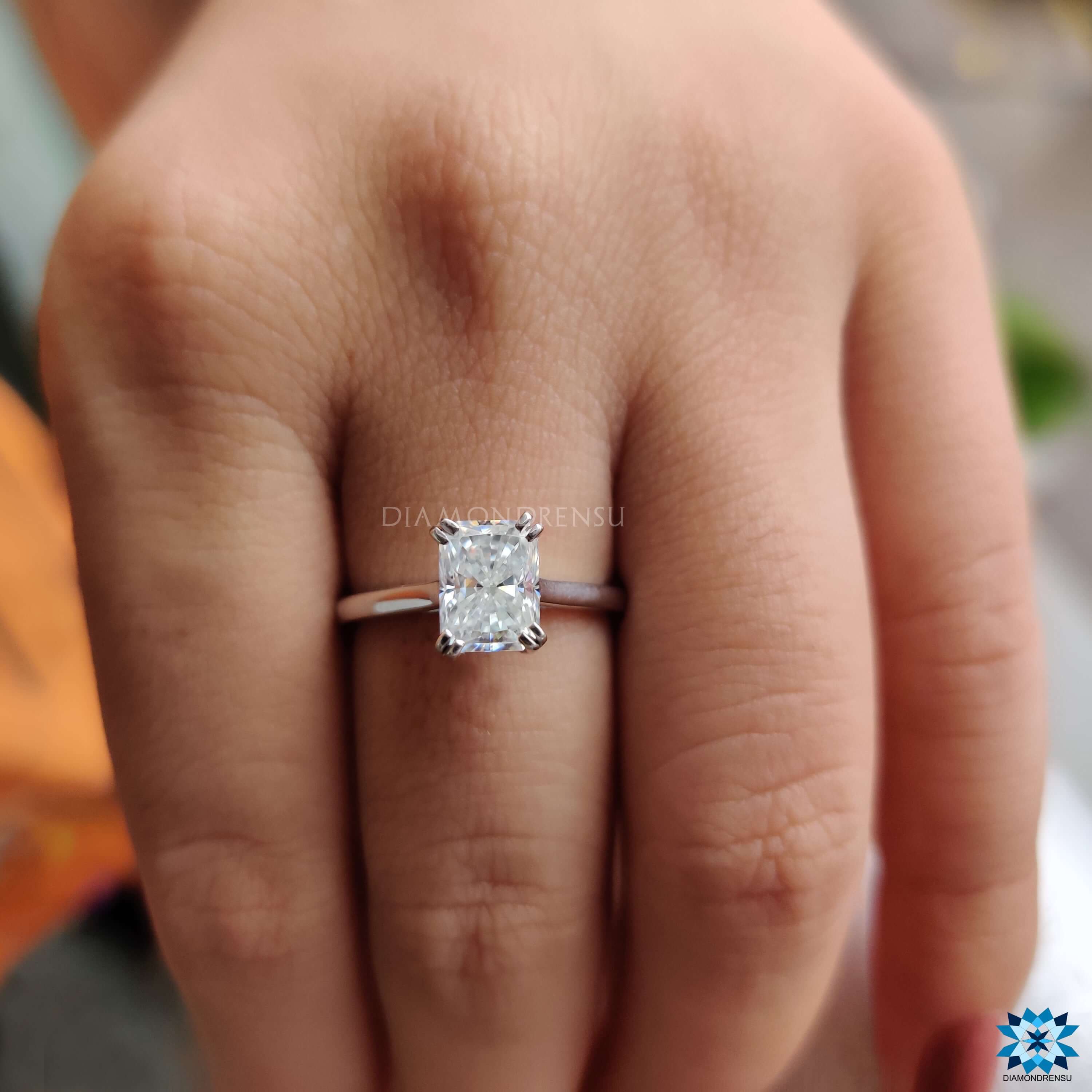 White gold solitaire ring with radiant cut center stone.