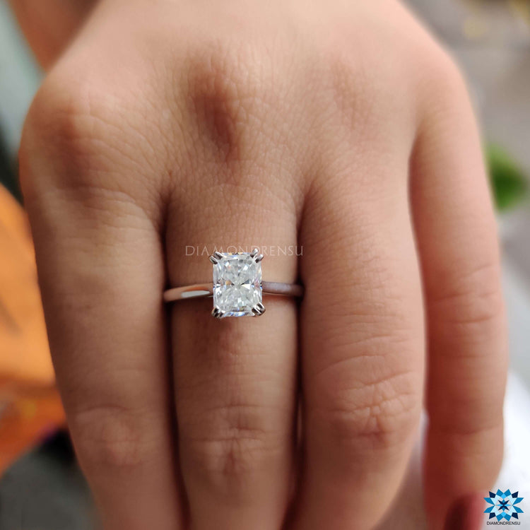 White gold solitaire ring with radiant cut center stone.