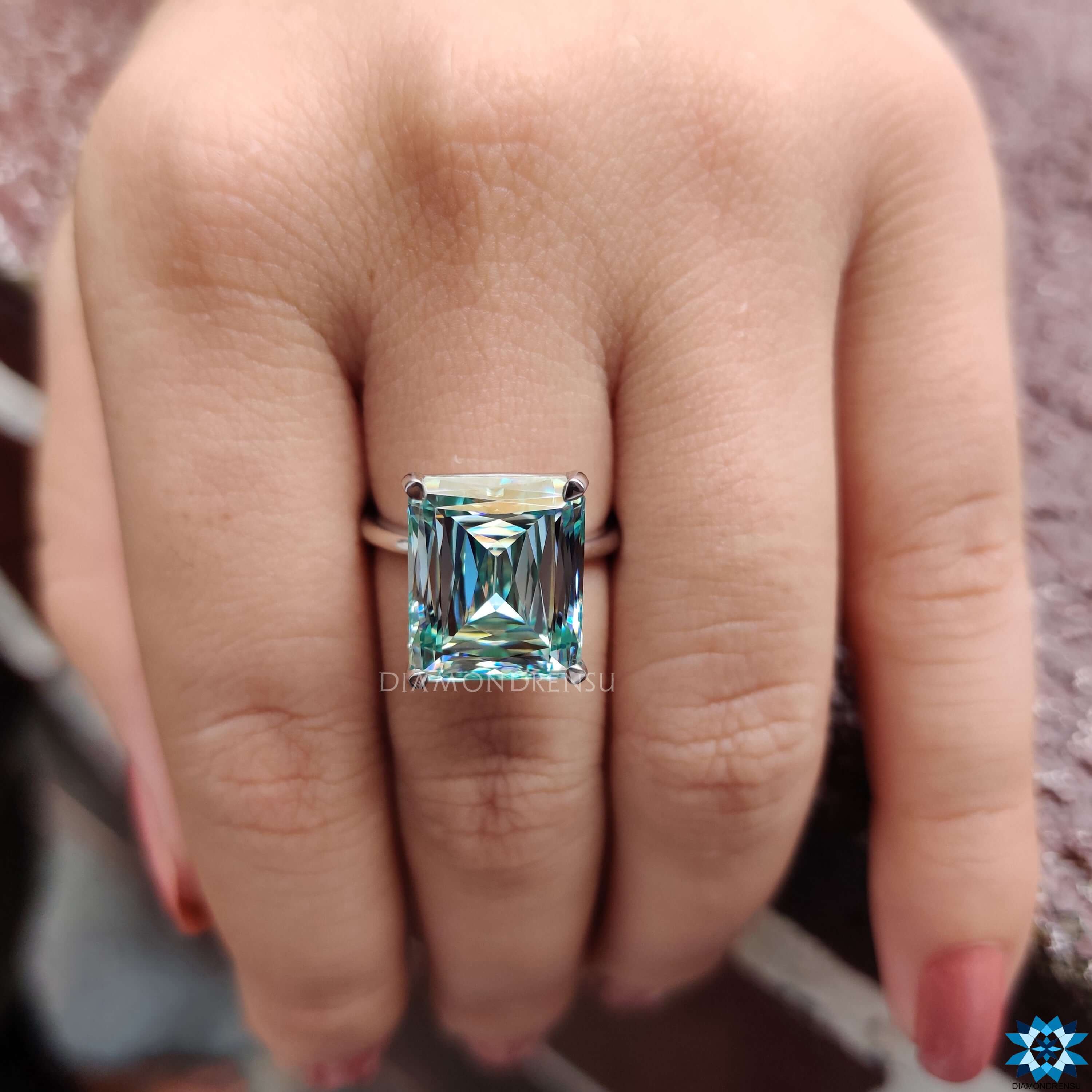 Cyan blue moissanite solitaire setting ring in white gold.
