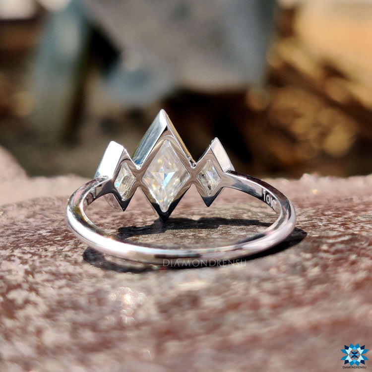 White gold three stone ring with lozenge center stone.