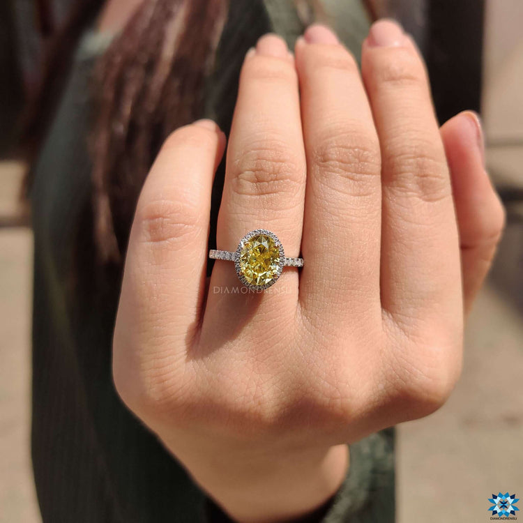 Round cut side stones complementing the oval center stone.