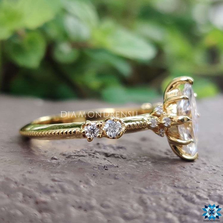 Muse setting moissanite engagement ring in yellow gold.
