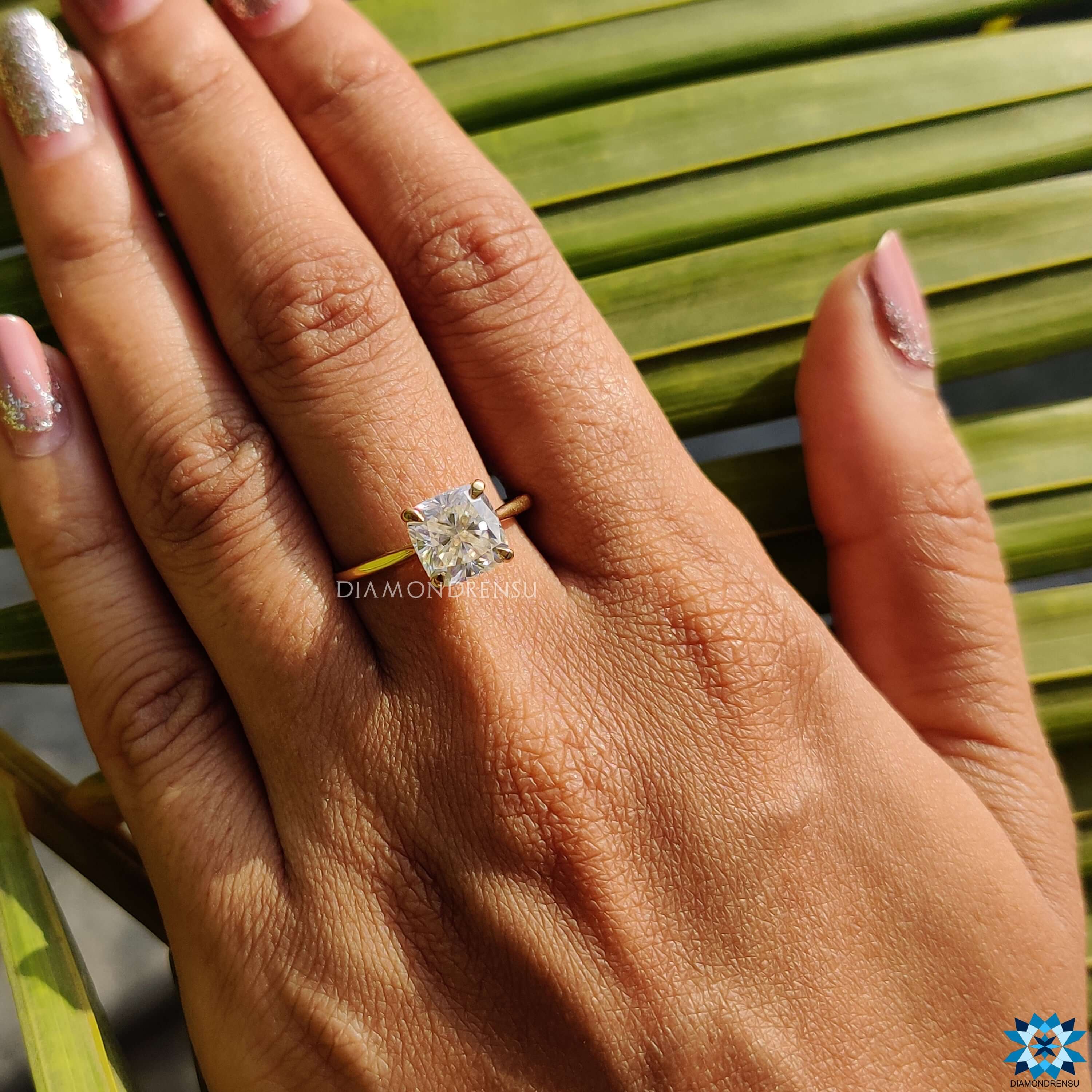 Moissanite solitaire ring with cushion center stone.