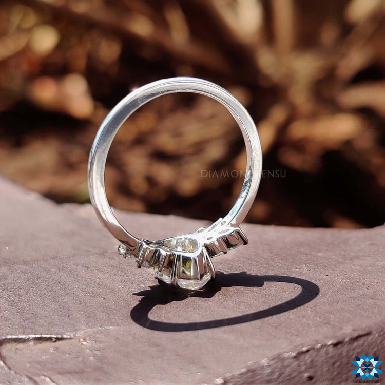 Handmade moissanite ring with marquise and round stones.