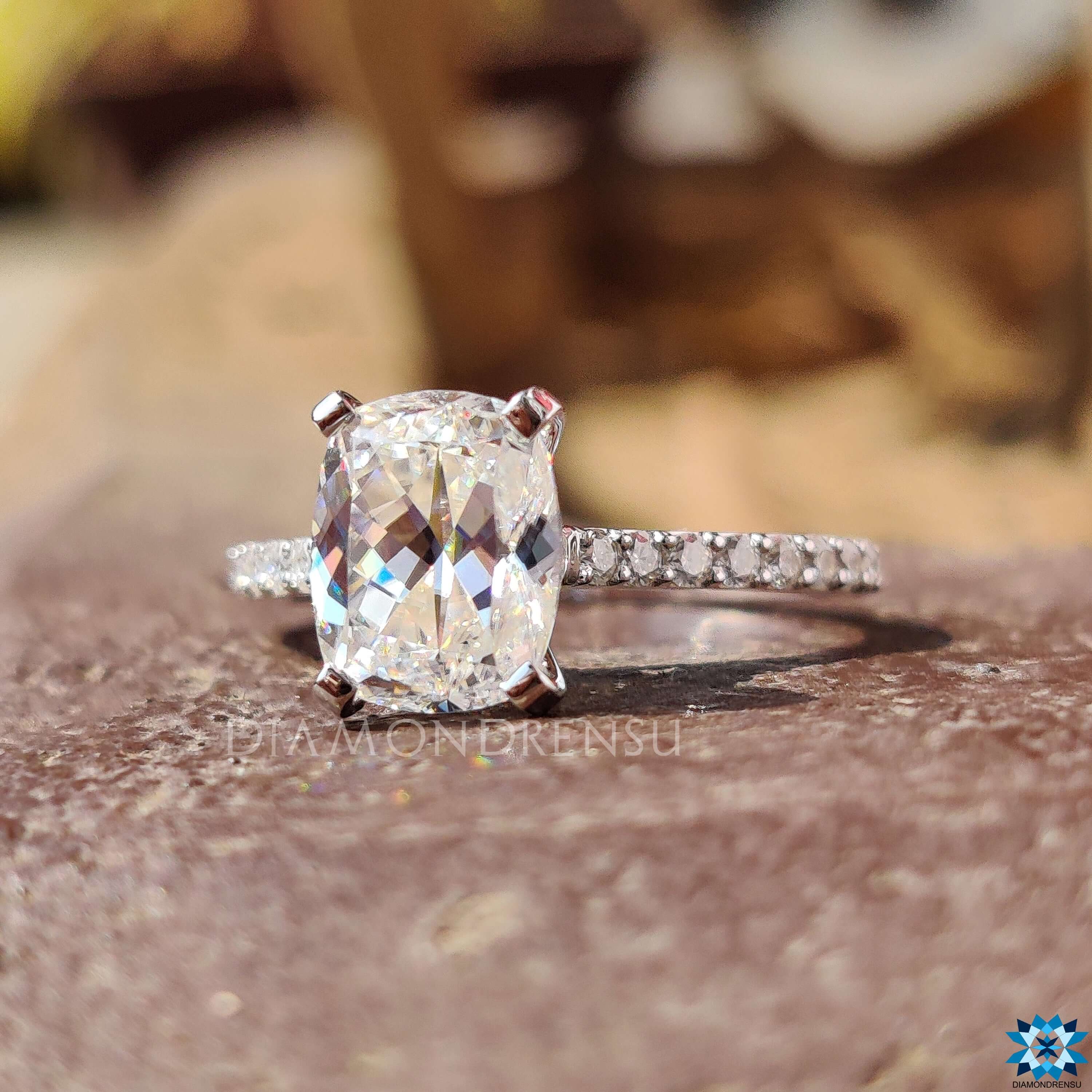 Moissanite engagement ring in white gold with round pave band.