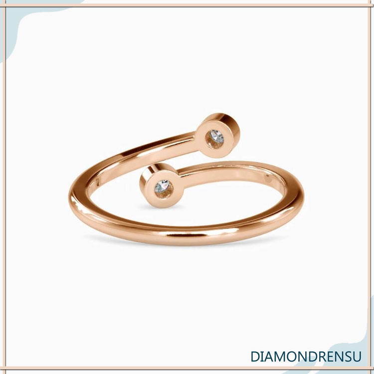 Rose gold open gap ring with bezel set diamonds.