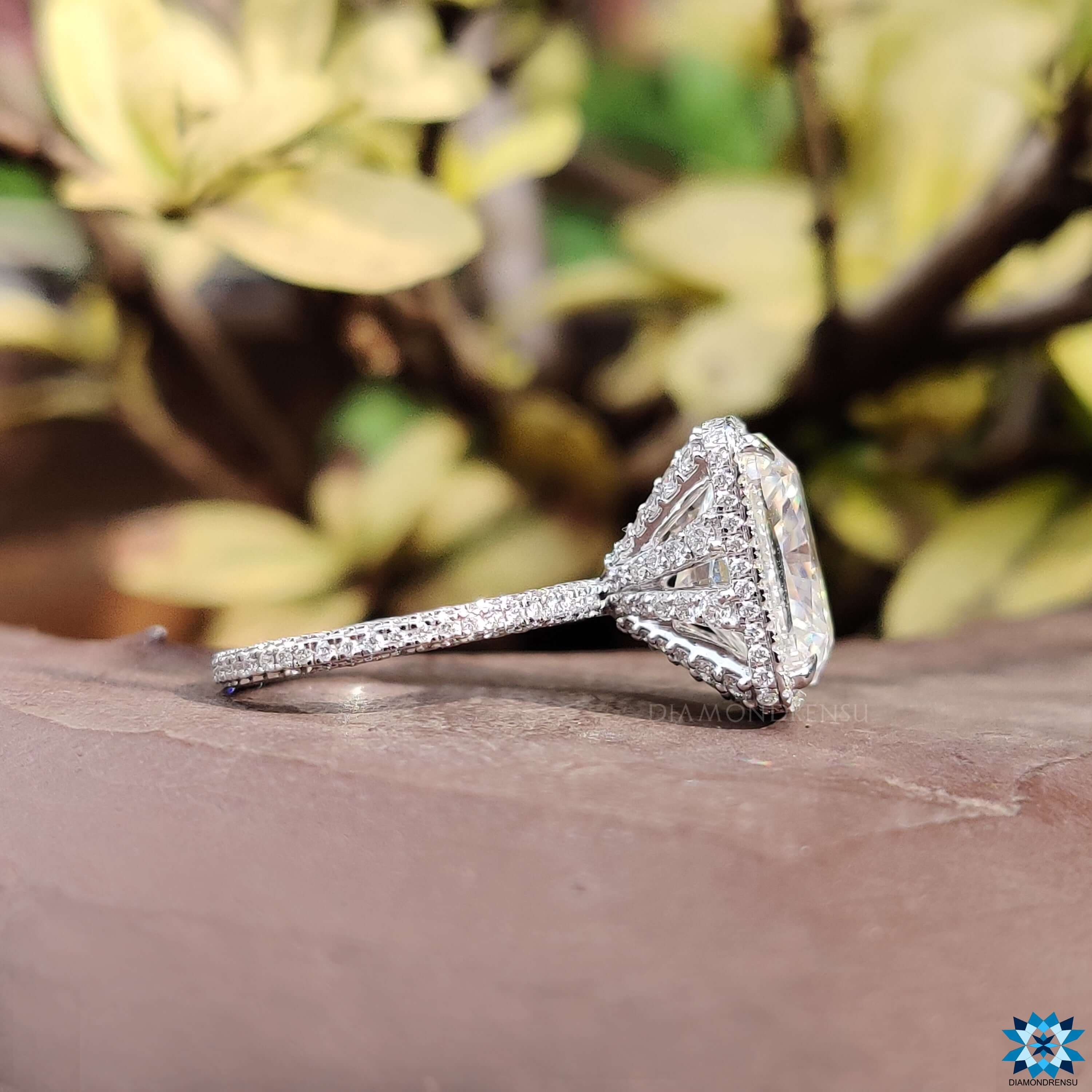 Pave engagement ring with cushion cut moissanite.