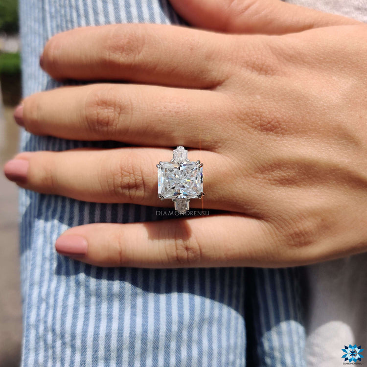 3 stone engagement ring with radiant center moissanite.