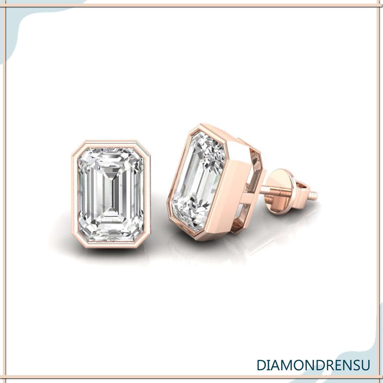 White gold diamond stud earrings with emerald cut stones.