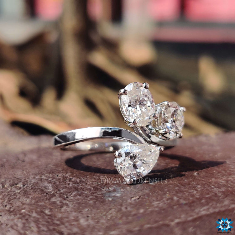 Prong setting ring featuring a trio of moissanite cuts.