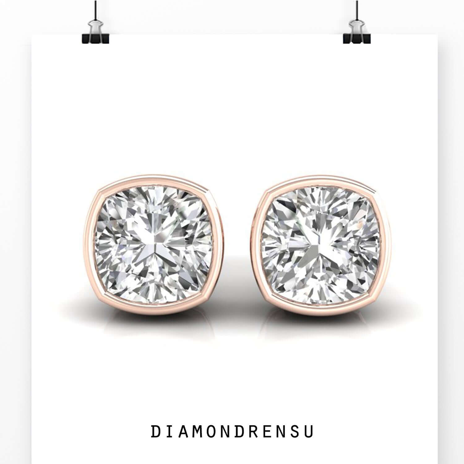 Gold diamond earrings in cushion bezel layout.