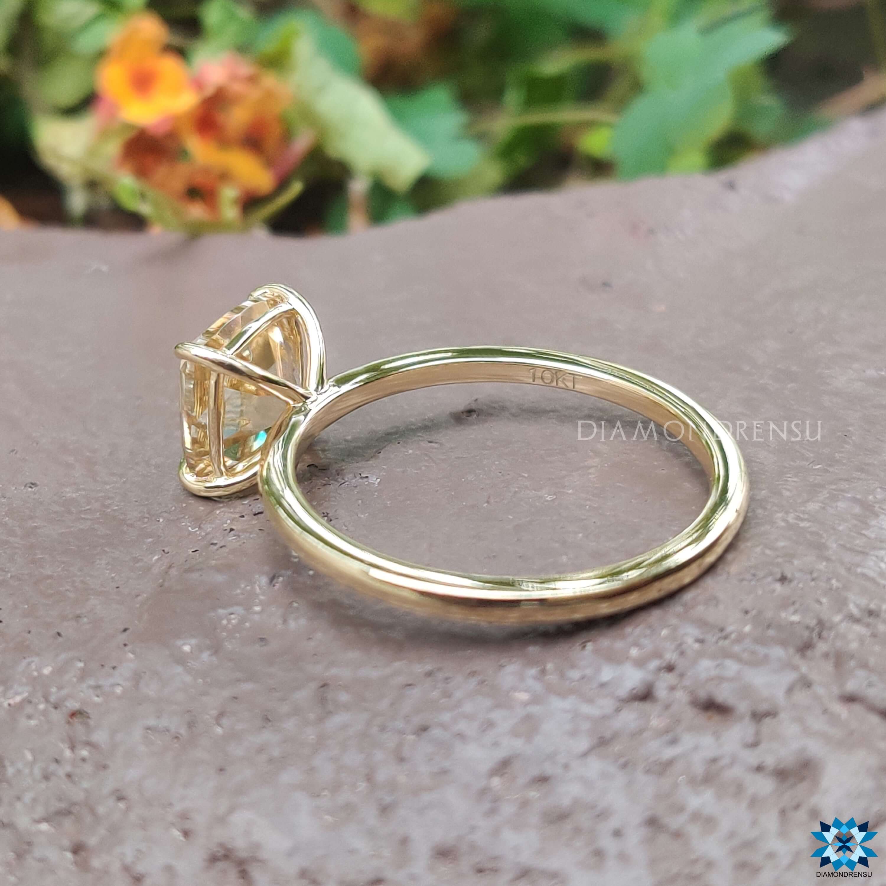 Handmade yellow gold engagement ring with claw prong.