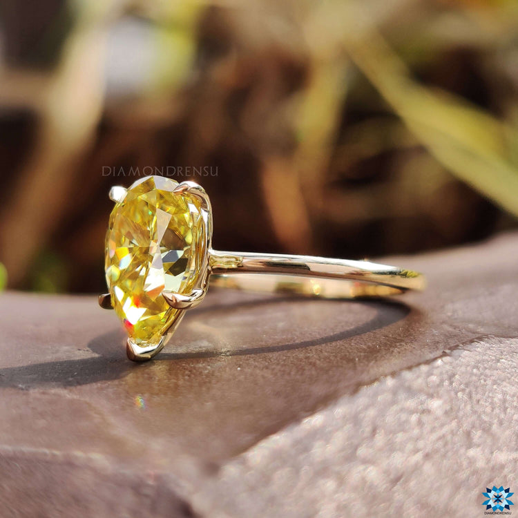 Solitaire engagement ring featuring pear shaped moissanite.