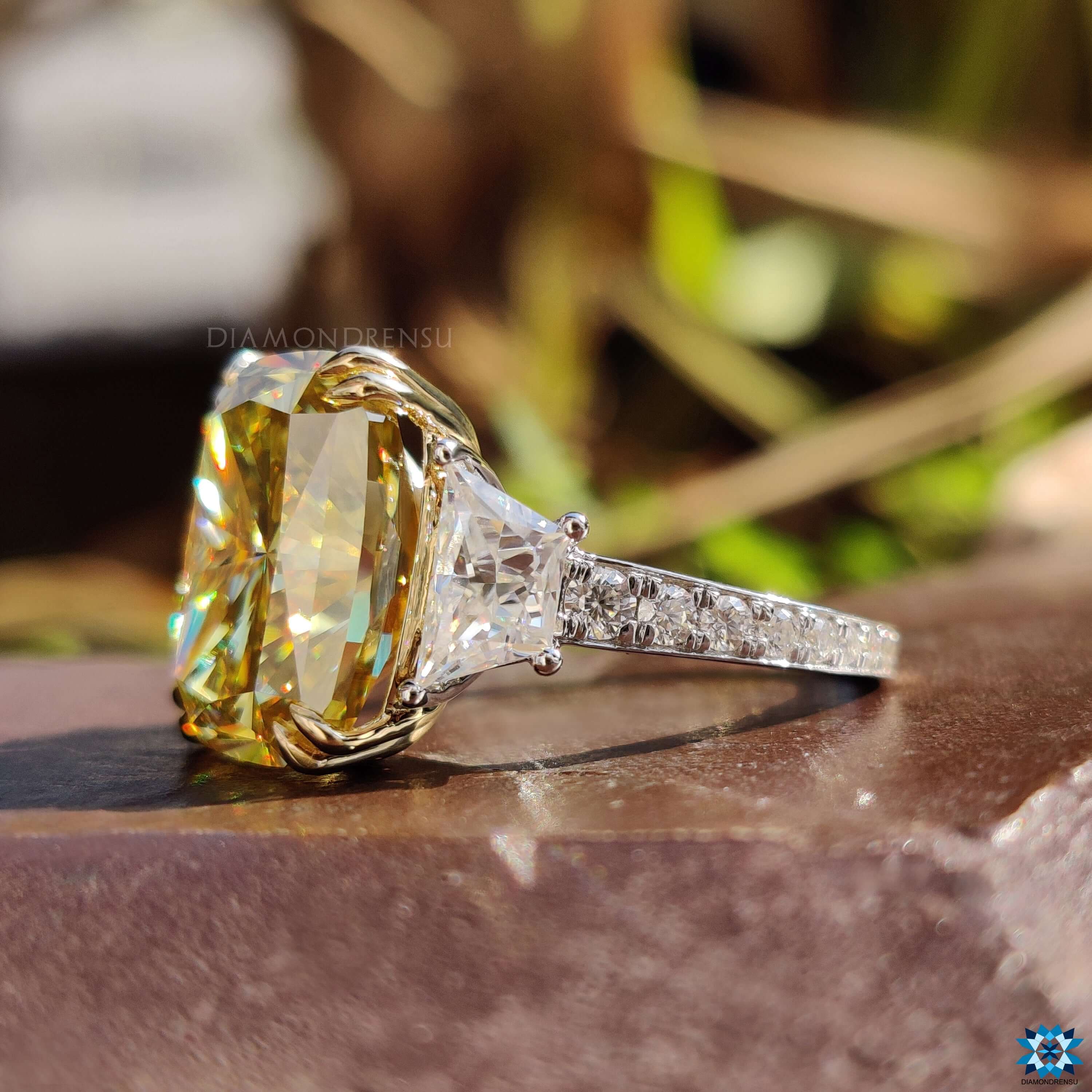 White gold engagement ring with three moissanite stones.