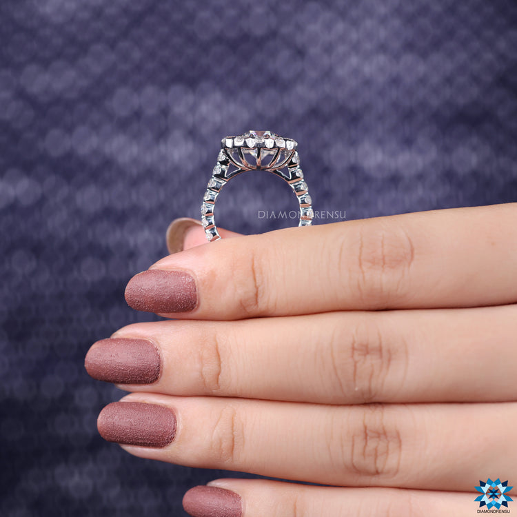 Round cut halo with cushion moissanite in custom white gold band.