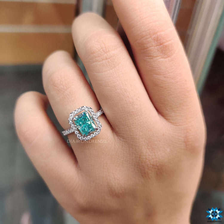 Halo setting moissanite ring with round pave band.