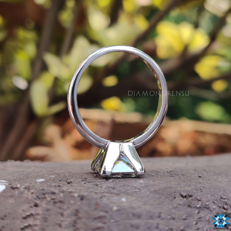 Elegant solitaire ring with princess cut and prong setting.