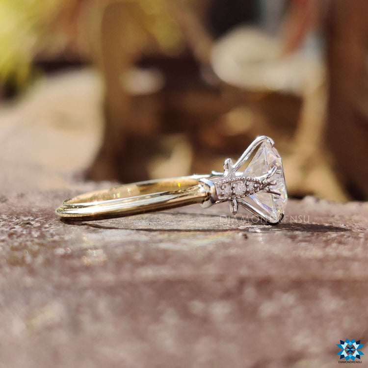 Handmade round moissanite ring in dual tone gold.