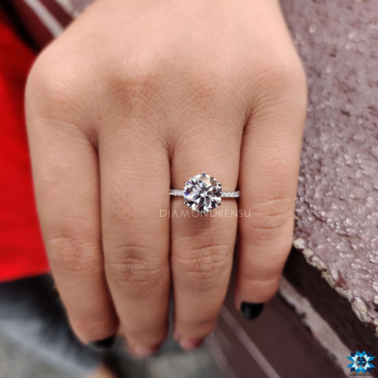 White gold moissanite ring with 6 prong and pave setting.