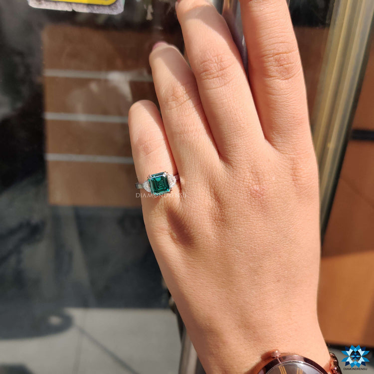 Asscher and epaulette cut moissanite ring in triple halo style.