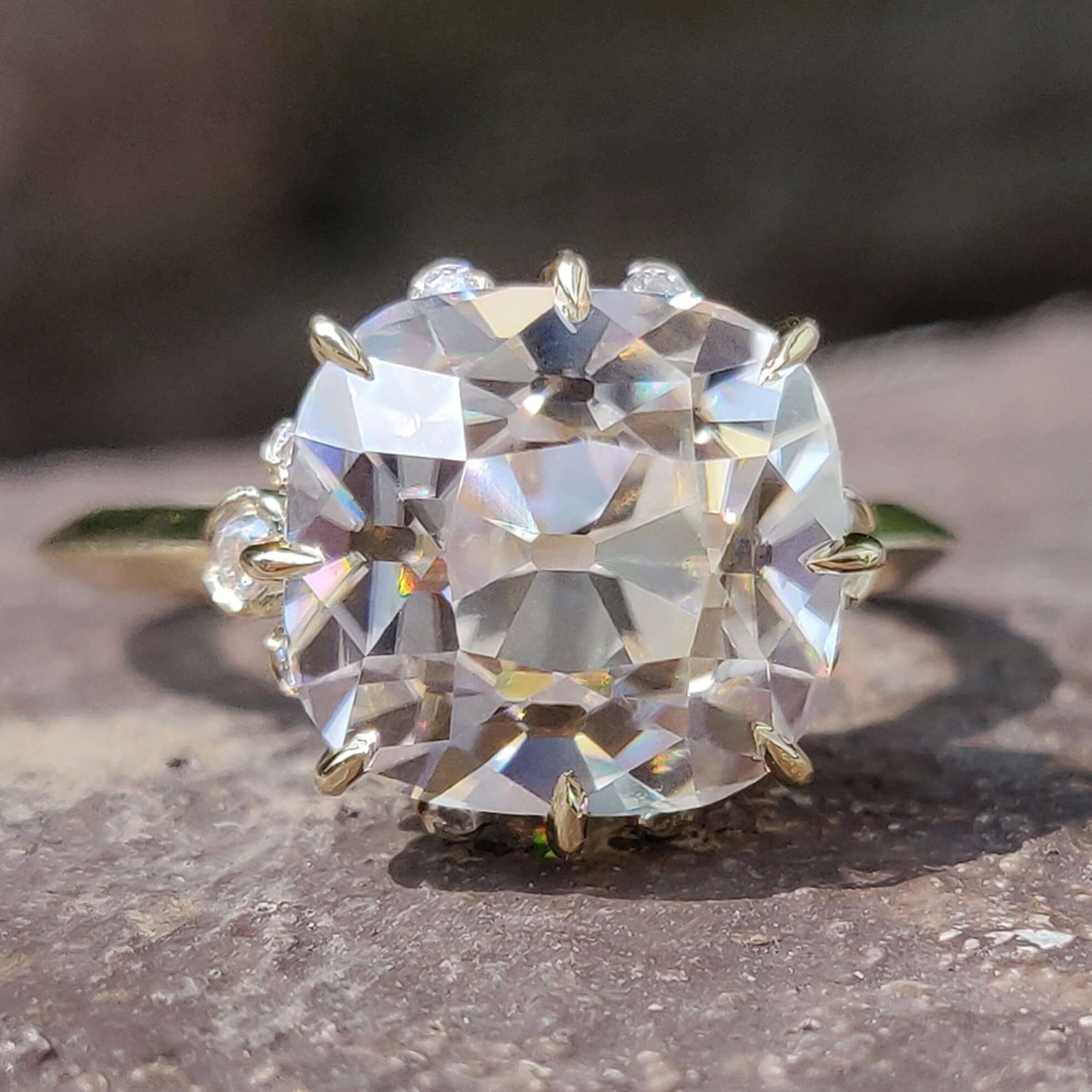 Cushion old mine cut moissanite engagement ring in yellow gold.