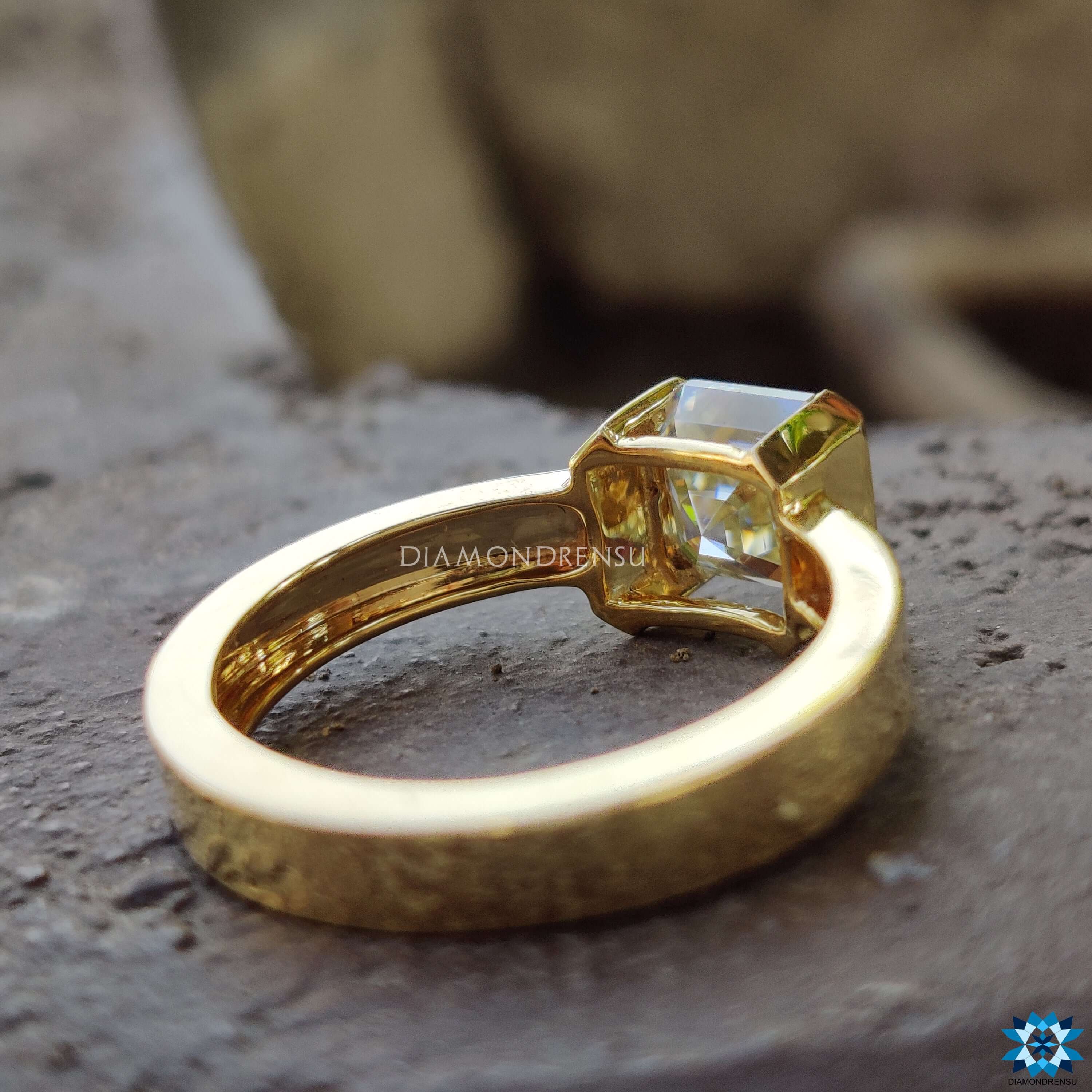 Custom moissanite engagement ring with half bezel setting.