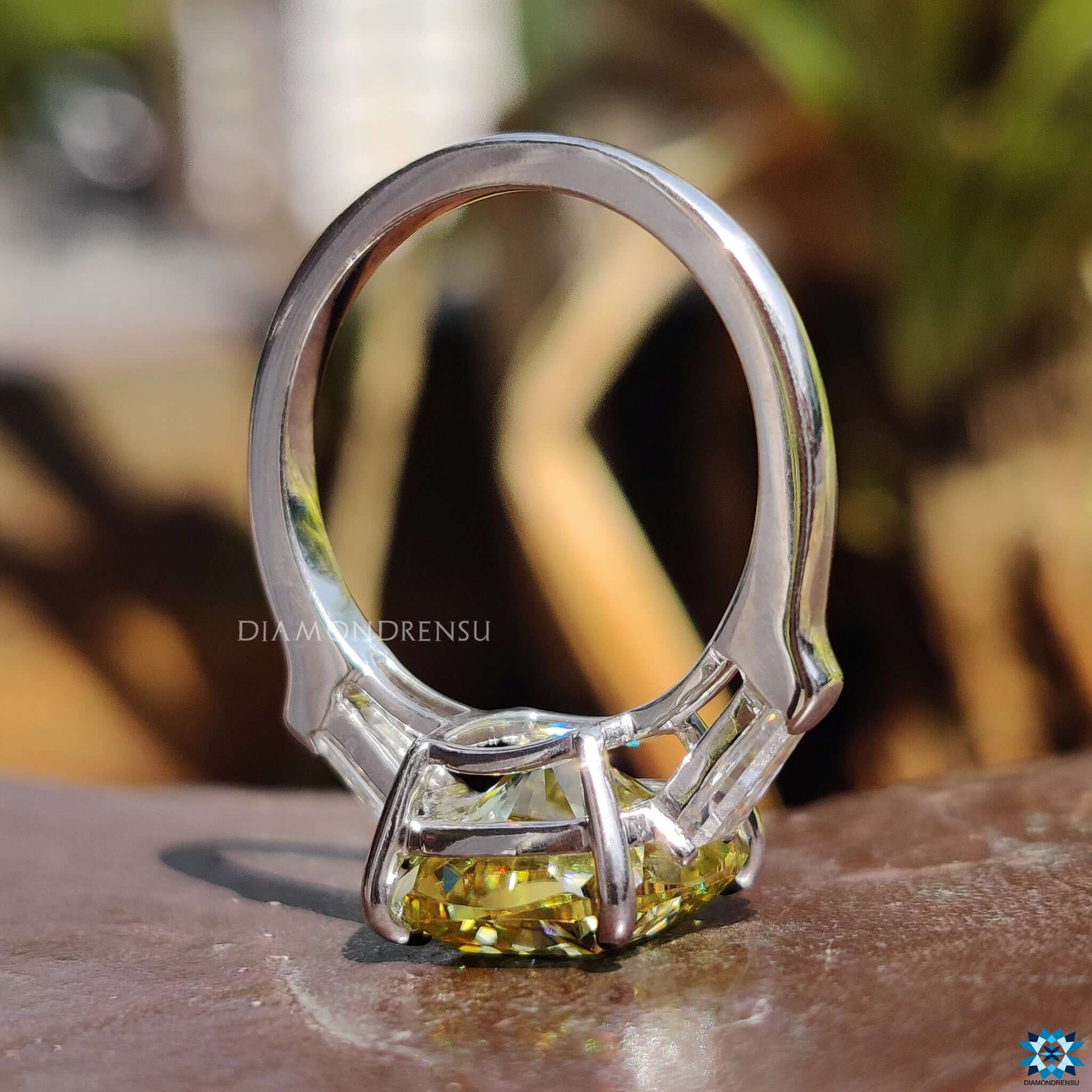 White gold ring with cushion cut center stone.