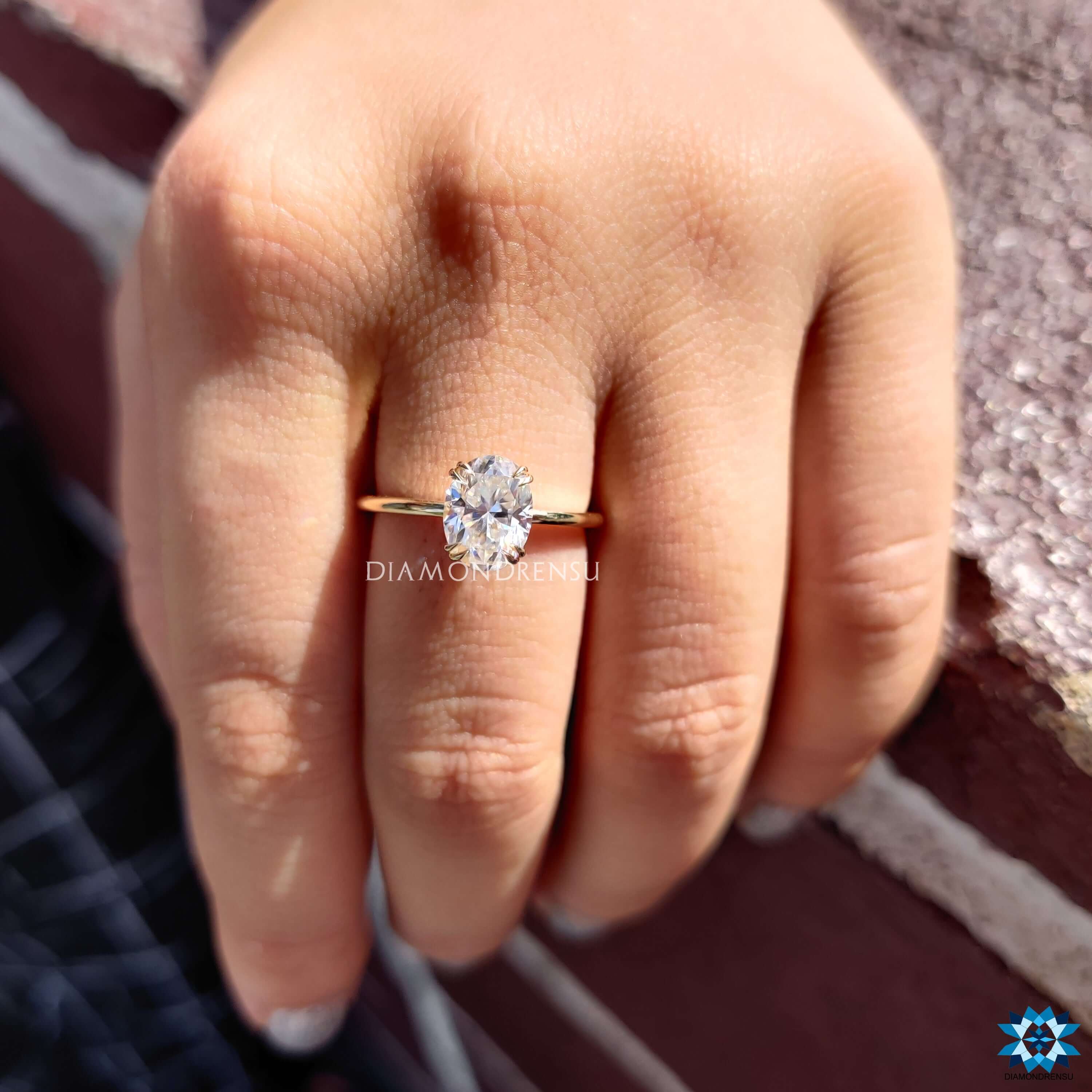 Yellow gold engagement ring with oval moissanite center.