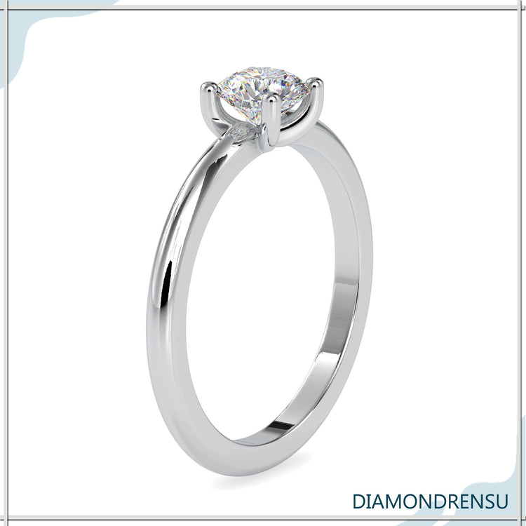 Handmade ring featuring solitaire setting in yellow gold.