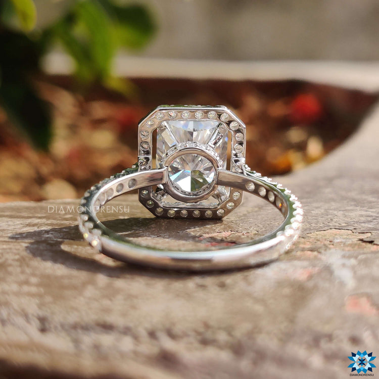 Handmade ring with radiant cut moissanite and detailed pave band.