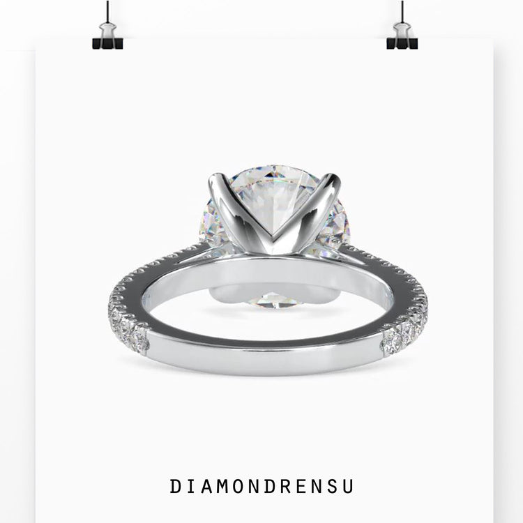 4 prong setting ring holding a round diamond with balance and support.