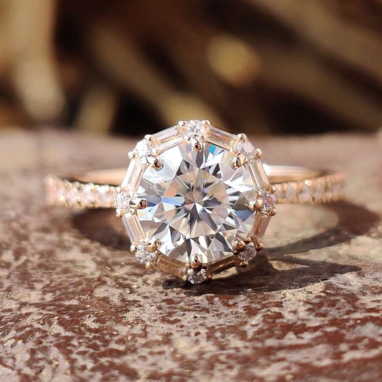 Rose gold halo engagement ring with round cut moissanite.