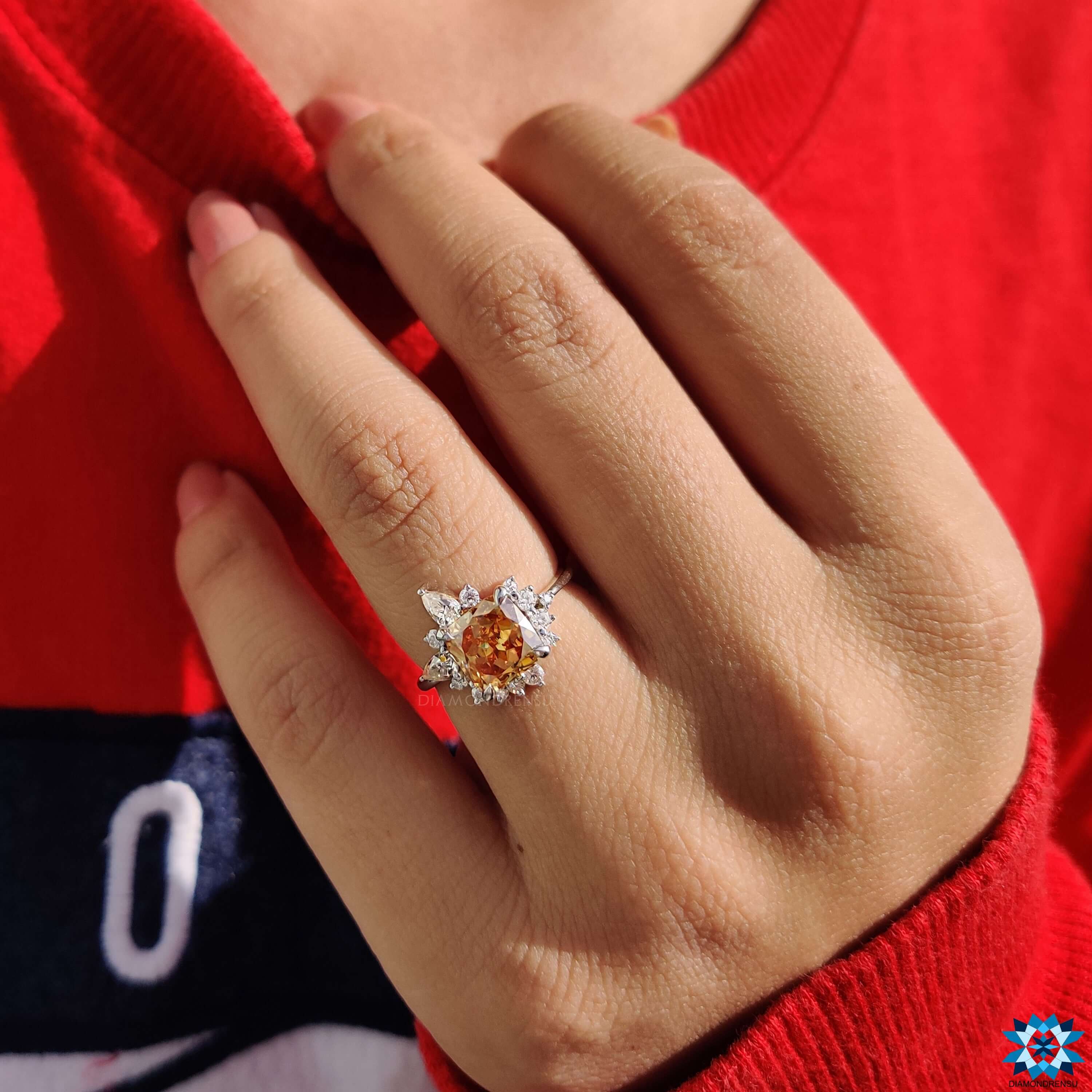 Prong set cushion moissanite ring with a unique trio of stone shapes.