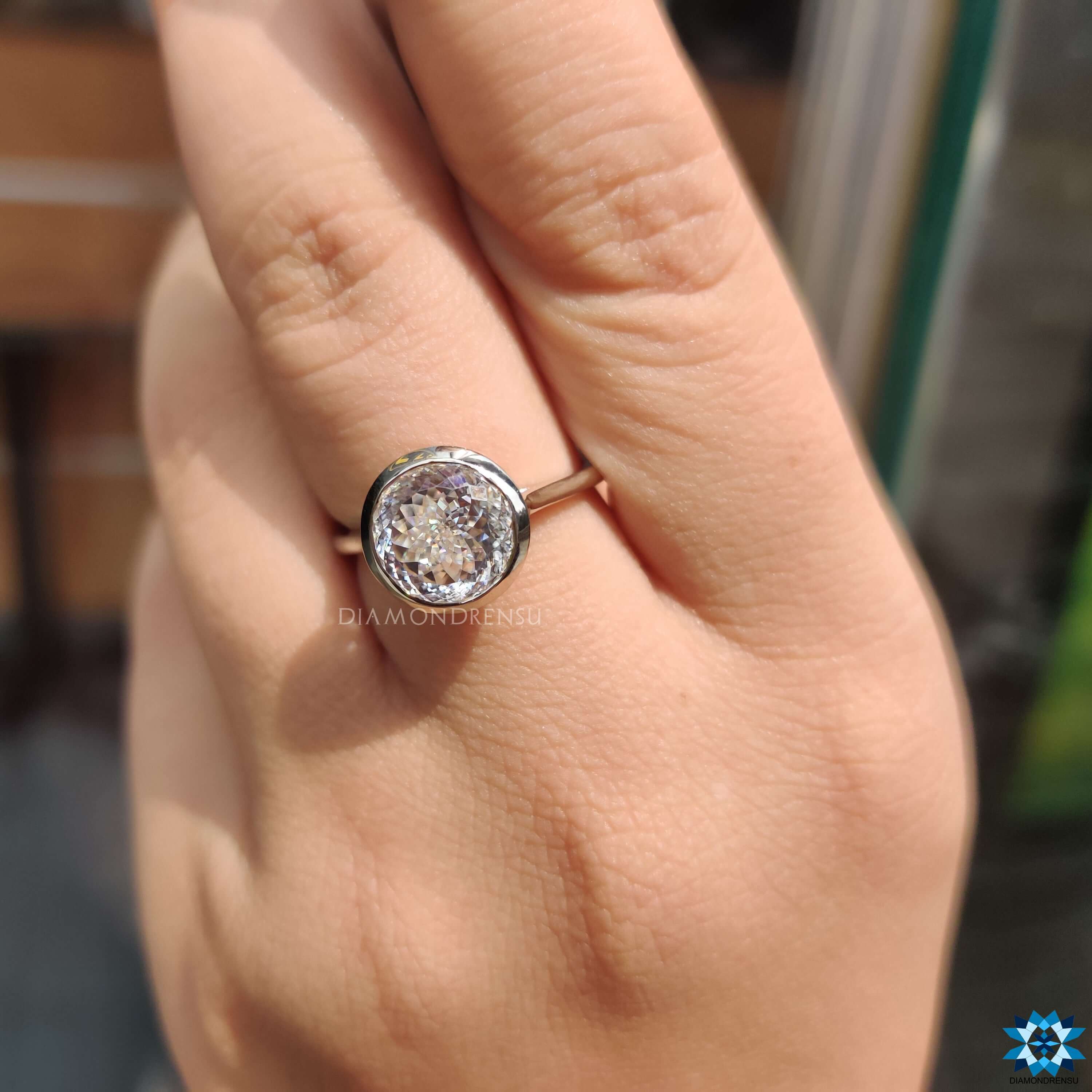 White gold ring with bezel and prong settings.