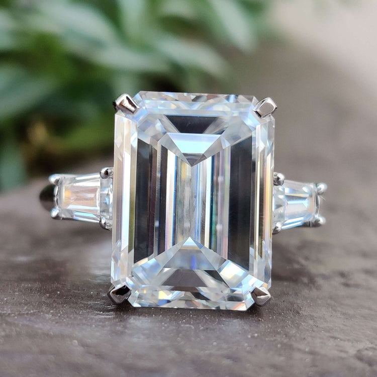 Emerald cut moissanite engagement ring in white gold.