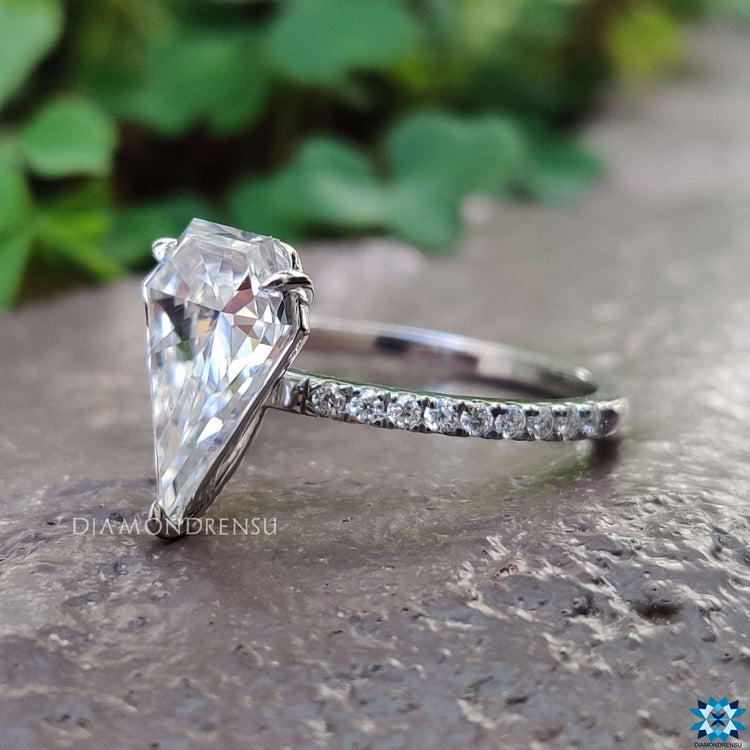 White gold engagement ring with round cut pave accents.