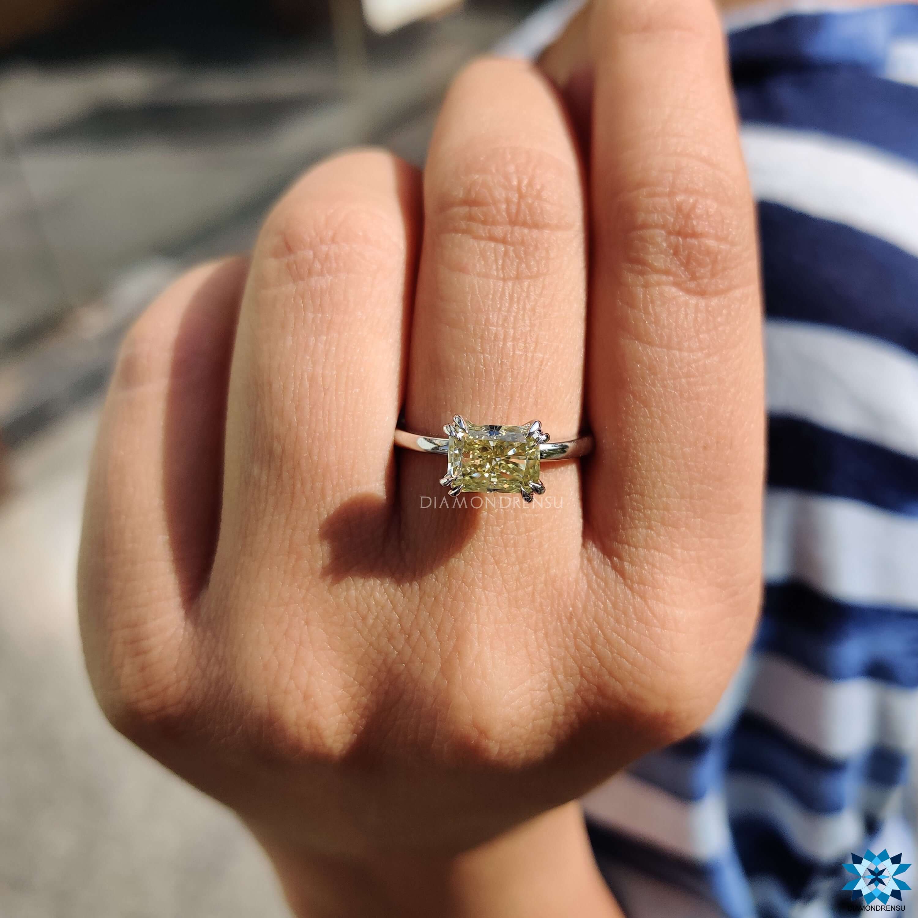 Pale yellow moissanite ring in solitaire setting.