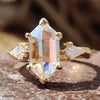 Three stone moissanite ring with hexagon center.