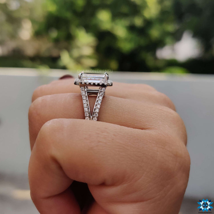 Custom emerald moissanite ring in claw prong setting.