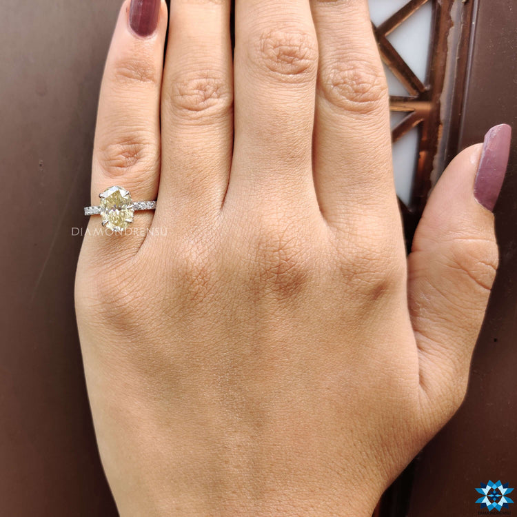 Pave setting ring featuring oval moissanite in claw prong.