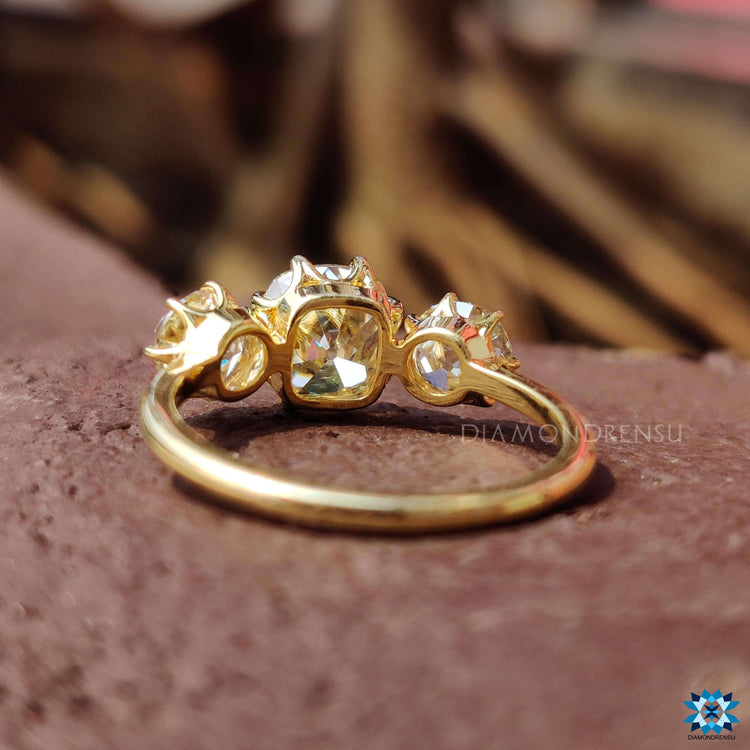 3 stone yellow gold ring with old mine and old European cuts.
