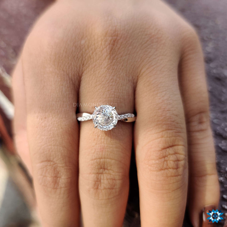 White gold ring featuring Portuguese cut center and round moissanite accents.